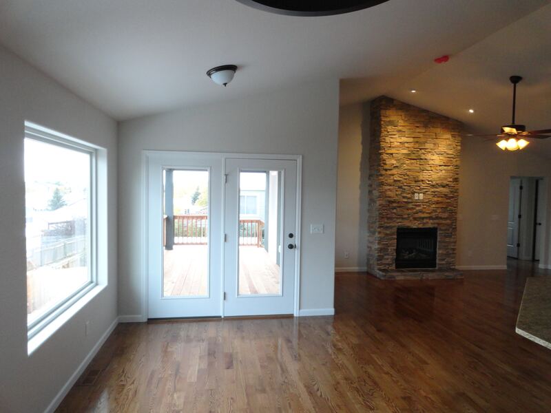 Dining area of a home built by Sheets Building & Contracting, with French doors to a wood deck